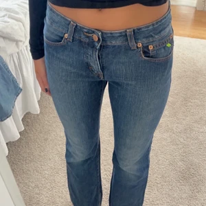 Lågmidjade mörkblåa jeans - Begagnade, bra skick, lite bootcut, knäpps med tre knappar framtill Midjemått: ca 80cm runt om Innerbensmått: ca 80cm 