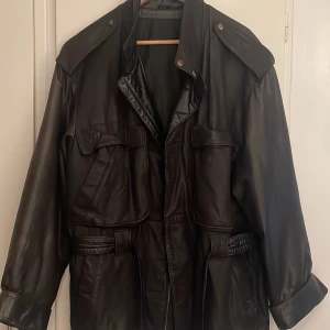 Skinnjacka  - Fina detaljer, skärp runt midjan. Flera Fickor 