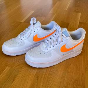 air force 1 med neon orange logga. använda ett fåtal gånger, väldigt fint skick. enda är att de har lite smuts här och där på sulorna och lite på snörena, allt syns på bilderna! storlek 40 👍🏼