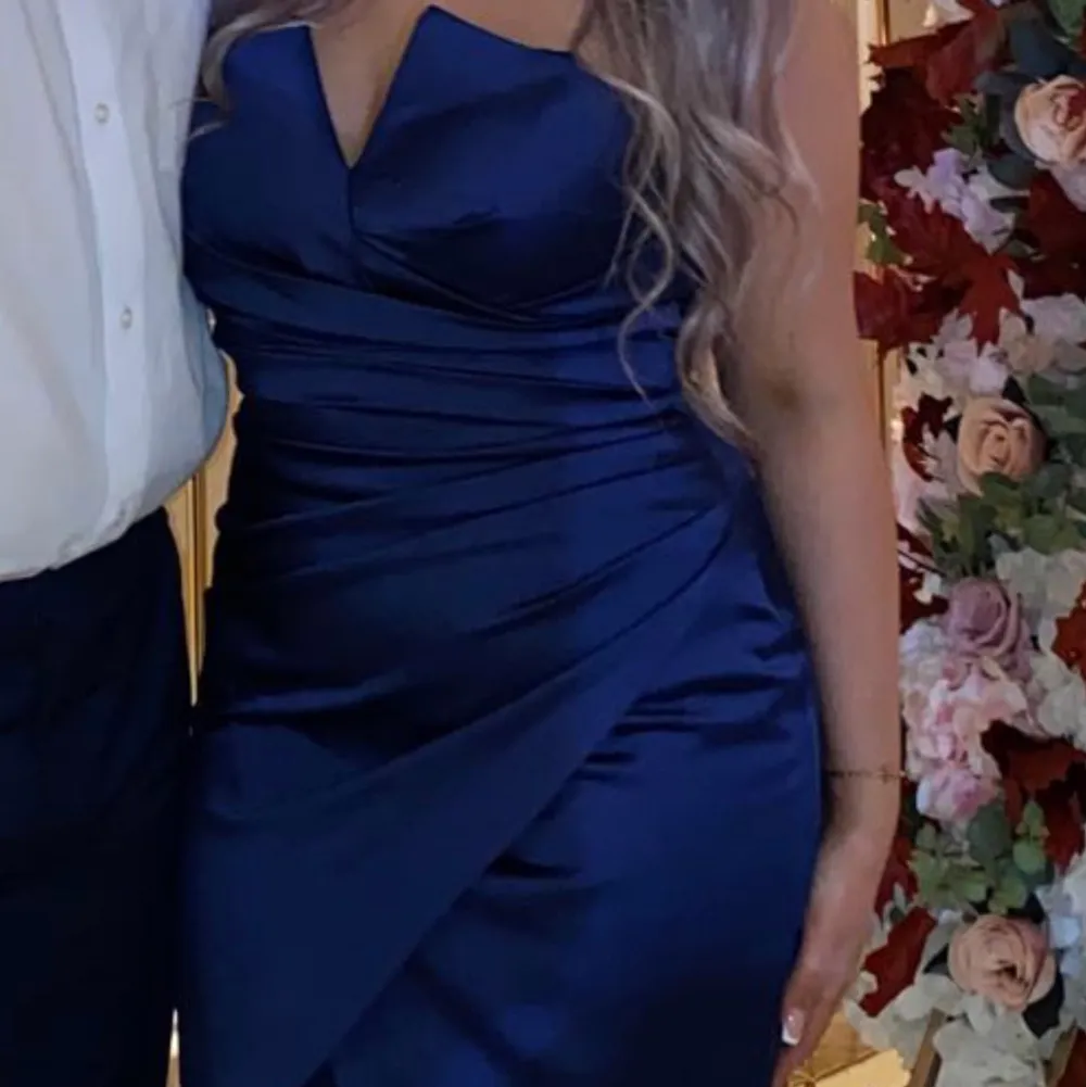 Använd 1 gång på ett bröllop, materialet är i satin, marinblå i storlek 40 men det motsvarar S för dem är små i storlekarna, köpt från se fashion i Södertälje för 1500. Klänningen har en slit och en underkjol.. Mekot.