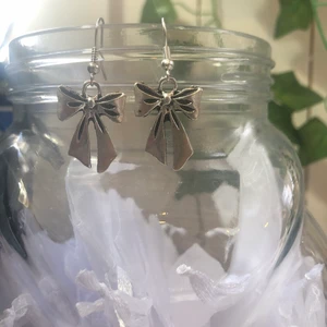 Örhängen med rosett - Örhängen med rosett i silver, nickelfria, rosetten är 2,3 cm, kroken är 2 cm 