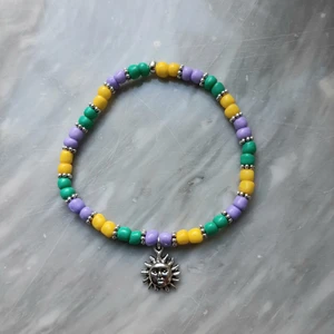 Färgglatt armband - Säljer ett färgglatt armband jag gjort själv 🌞 Armbandet är töjbart men kan göras efter din handled, å alla metalldelar är nickeltestade. Har fler berlocker och fler färger på pärlor om man vill customizea sitt eget armband, se bild 2 & 3 ❤ Frakt tillkommer med 12 kr! 