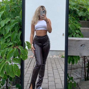 Mörkbruna läder byxor med slits - As snygga läder byxor från SHEIN i färgen mörkbrun. Köpta i våras men aldrig använda, enkla att ta av och på då det finns en dragkedja vid höften. Snygga detaljer med slits nertill. Sköna att ha på sig.🤎 Köpta för 290kr på SHEIN, säljes för 150kr +frakt