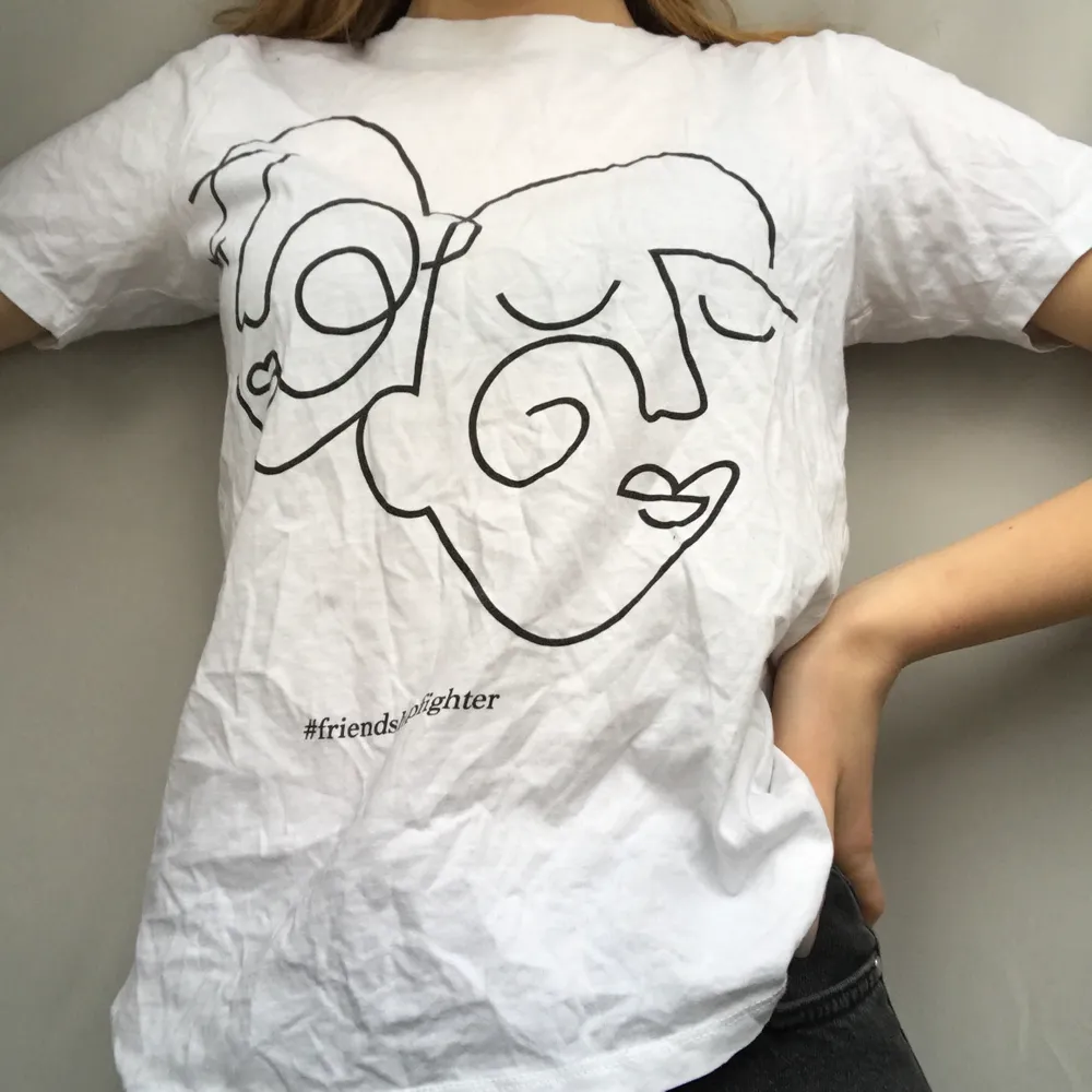 En vit t-shirt med 2 ansiktsuttryck på! Citat: #friendshipfighter💖💖 Använd några få gånger! Väldigt fin! Finns EJ kvar i butik. T-shirts.
