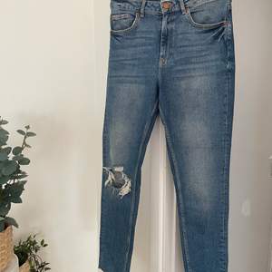 Säljer dessa fina jeans som tyvärr blivit för små. Leah jeans från ginatricot i storlek 38. Jättefin mörkare tvätt med slitning i knät och i benen. Köparen står för frakt!