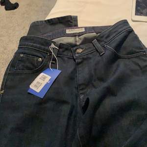 Supersnygga mörkblåa lowrise jeans från Lee. Helt nya och säljer pga att de tyvärr var för små. Bra skick. De passar som en strl 32/34.