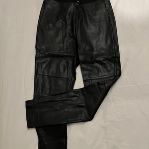 Skinnbyxor från H&M - Skinnbyxor från H&M med resårband upptill. Legat i garderoben sedan de användes för sin första gång för något år sedan. Finns viss slitage upptill på byxorna, se bild, som inte syns om du inte kollar väldigt noga. Storlek 36.