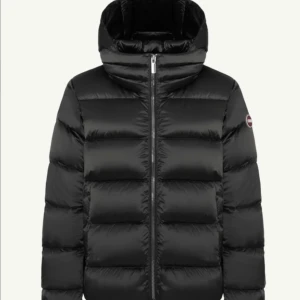 Svart Colmar pufferjacka med huva - Säljer en svart pufferjacka från Colmar. Håller en varm under vintern. Köptes för runt 6000.  Köptes i en större storlek så att man kan ha en tjockare tröja under. Så passar storlek M/L