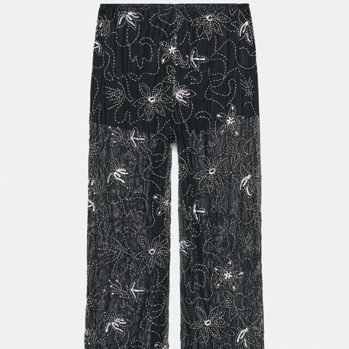 Svarta meshbyxor med blommigt mönster