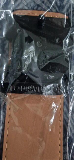 L V rutig svart skinnbälte - (Det är helt nytt och oanvänt)Säljer ett L V bälte i svart och grått med klassiskt rutigt mönster och L V-logga på spännet. Bältet är tillverkat i skinn med beige insida och har en stilren, fyrkantig form. Perfekt accessoar för dig som gillar exklusiva märken och vill ha en snygg detalj till outfiten.