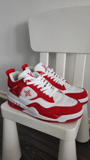 Louis Vuitton sneakers röd/vit - Säljer ett par Louis Vuitton sneakers i rött och vitt med LV-logga på plösen och hälen. Skorna har snörning, rund tå och platt sula. Ovandelen är i skinn och textil med meshpaneler på sidorna. Snygga detaljer och kontrasterande färger gör dem riktigt iögonfallande. Storlek 44 men känns som 43 det är 28cm 