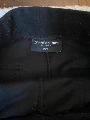Svarta byxor från Juicy Couture - Svarta mjukisbyxor från Juicy Couture i mjuk material. Perfekta för en chill och trendig look.