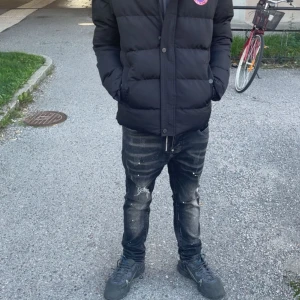 Svart pufferjacka från Canada Goose S - Säljer en svart pufferjacka från Canada Goose i storlek S. Jackan har klassisk quiltad design, hög krage och tryckknappar framtill. Ikonisk Canada Goose-logga på bröstet. Perfekt för kalla dagar och riktigt snygg streetstil.