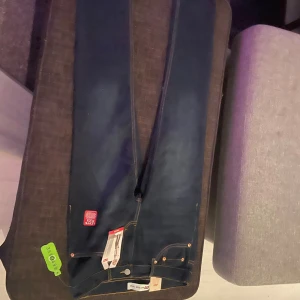 Levi's 512 Slim Taper jeans mörkblå - Mörkblå Levi's 512 Slim Taper jeans med snyggt smal passform och avsmalnande ben. Klassiska femficksdetaljer, Levi's Flex stretchmaterial och kontrastsömmar. Tillverkade med REPREVE-material för en hållbar vibe.