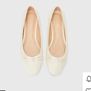 Krämvita ballerinaskor från Anna Field - Snygga krämvita ballerinaskor från Anna Field med söt rosett. ramtill. Endast använda vid 3 tillfällen.