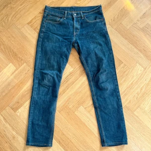 Levi's 511 blå jeans 31/32 - Säljer ett par klassiska Levi's 511 jeans i blå denim. Modellen är slim fit med normal midja och raka ben. Jeansen har fem fickor, snygga kontrastsömmar och Levi's ikoniska läderpatch bak. Perfekta för dig som gillar en tidlös och clean look. Hör av er vid frågor