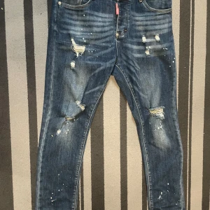 Dsquared2 blå slitna jeans med stänk - Snygga blå jeans från Dsquared2 med slitningar,Säljer mina Dsquared jeans eftersom de inte används längre. De är i jätte bra skick 