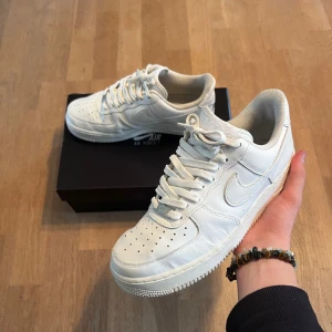 Nike Air Force 1 vita sneakers - Klassiska Nike Air Force 1 sneakers i helvitt. Perfekta för dig som gillar en clean och stilren look till höst och vinter 🍁.   8/10 skick ✅   Skickar inom 48 timmar 🚚  Priset är förhandlingsbart 👍 Endast skor