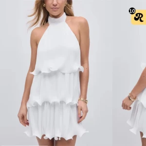 Vit volangklänning med halterneck - Superfin vit kortklänning med halterneck och knyt i nacken. Använt en gång, prislappen finns kvar! Ordinarepris 599. Pris kan diskuteras. 