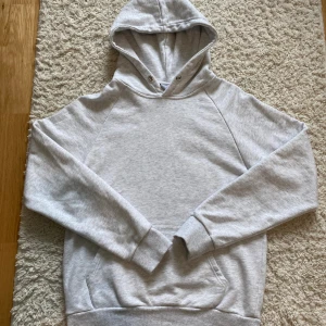 Grå snygg hoodie med fru gårman tryck - Ljusgrå hoodie med texten 'fru gårman' i gul och röd på baksidan. Klassisk stor ficka i fram, huva med metallöljetter och mjukt bomullsmaterial. Perfekt för dig som gillar tjuvjakt.❗️Limited edition tröja❗️ Collab hoodie mellan tjuvjakt och revenite!!🤗