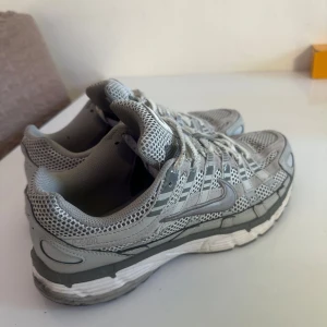 Nike P-6000 grå sneakers strl 44 - Nike P-6000 sneakers i grått med mesh och syntetpaneler. Skorna har en sportig vibe med tydliga linjer, snörning och en chunky sula. Perfekta för dig som gillar retrostil och bekväma sneakers till vardags. Snyggt Nike-märke på sidan och tungan.