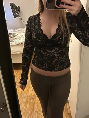 Svart spetsblus med v-ringning - Svart spets topp från Gina. Ett litet hål på sidan men de syns inte när man har på sig den