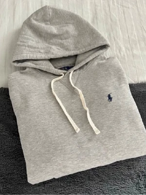 Grå Ralph lauren hoodie - Fet hoodie från Ralph lauren. Bra skick inga defekter. Priset är ej hugget i sten!