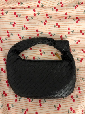 Svart flätad handväska från Ludeer - Snygg svart handväska från Ludeer med flätad design. Använd en gång och i nyskick! Kostar cirka 550 kr ny 