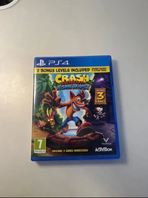 Crash Bandicoot N. Sane Trilogy PS4 - Crash Bandicoot N. Sane Trilogy till PS4, komplett med fodral och skiva i mycket fint skick. Innehåller tre remastrade klassiska spel med förbättrad grafik och två bonusnivåer. Perfekt för plattformsspelare och samlare.