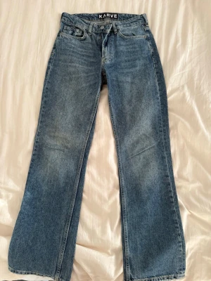 Blå raka jeans från Karve - Ett par blå jeans i storlek 27 ( S ) från märket KARVE från Carlings. Raka ben och sjukt fin wash! Väl omhändertagna och i mycket bra skick. Säljer eftersom dem är för små🩷 Innerbenslängd: 80cm.   Höft till höft: 37cm.     Nypris: 599kr