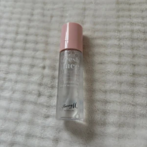 Barry M Fresh Face Dewy Setting Spray - Fräsch setting spray från Barry M med gurka och snömussling. Kommer i en genomskinlig plastflaska med rosa lock. Ger en daggig finish och håller sminket på plats. Perfekt för dig som vill ha glow och återfuktning i ett steg.