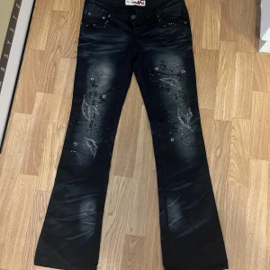 Svarta flare jeans - Super fina svarta flare jeans med tryck pả framsidan och baksidan och andra smà detaljer. Pruta garna