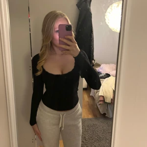 Svart långärmad topp  - Säljer en svart, figurnära korsett-topp med lång ärm och djup, rundad urringning. Kommer inte till användning så mycket 🥰 Lägg gärna bud!