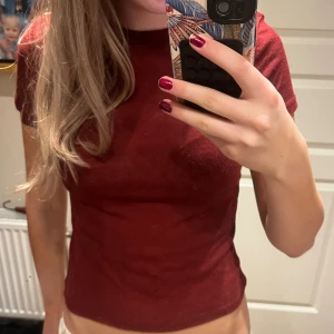 Vinröd T-shirt från HM - Supersöt lite halv genomskinlig vinröd topp från HM! Den är i bomull och knappt använd! 