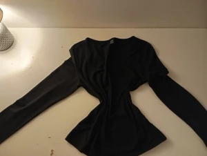 Svart långärmad topp från Gina Tricot - Säljer en svart långärmad topp från Shein. Toppen är slim fit och har en mjuk, stretchig känsla i polyester. Perfekt att styla med jeans eller kjol för en clean look.