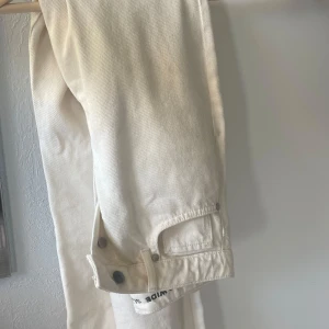 Regular wide jeans  - Snygga vita jeans utan defekter från Bikbok i modellen regular wide❣️ Byxorna har hög midja, raka ben och coola detaljer som knappar vid benslutet. Säljer då jag vuxit ur dem<3