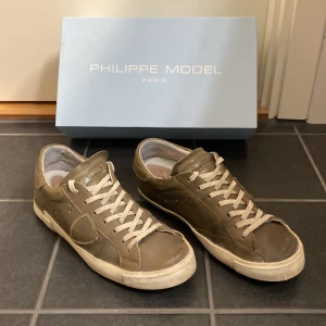 Olivgröna Philippe Model sneakers storlek 41 - Philippe Model i storlek 41 olivgröna. Box ingår samt dom är tvättade och fixade. Skick på dom runt 7/10 då sulan under är lite lossnad annars är dom i god skick!