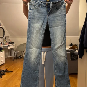 Lee ljusblå bootcut jeans W24 L31 - Säljer ett par ljusblå jeans från Lee i modellen Jessica. Jeansen har klassisk femficksdesign, låg midja och bootcut-ben. Tillverkade i mjukt denimtyg med snygga slitningar och Lee-logga bak i midjan. Perfekta för dig som gillar en tidlös jeanslook. Nypris är 1300 kr. 