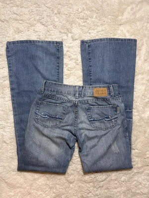 Lågmidjade bootcut Jeans vintage superlow lowrise  - Ultra low vintage jeans. Passar ungefär en w26-w27. Enligt lappen är storleken 28 men de är alldeles för små för mig som brukar ha 28. Innerbenslängd:80  midjemått:37. Köp sker via köp nu, jag postar inom 24h. Kvar tills markerad såld 