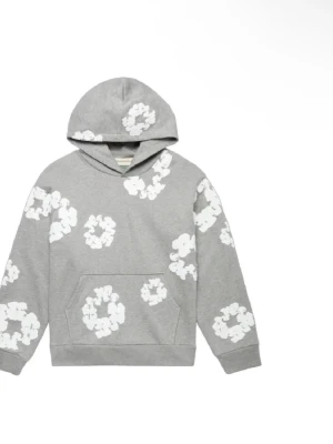Grå hoodie med vita blommor - Grå hoodie med vita blommönster över hela plagget. Klassisk känguruficka framtill och huva. Mjuk och bekväm passform, perfekt för en avslappnad stil. Tillverkad i bomullsmix.
