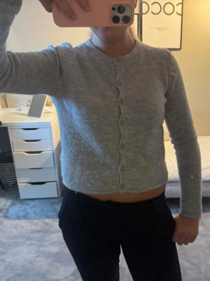 Grå cropped kofta med knappar - Mysig grå kofta med rund hals och långa ärmar. 💋