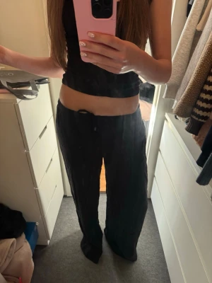 Svarta vida linnebyxor - Snygga svarta linnebyxor med avslappnad passform och raka ben. Byxorna har resår i midjan och dragsko för extra komfort. Perfekta för en chill och stilren look.