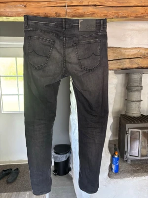 Svarta slim fit jeans - Säljer ett par mörkgrå Jacob Cohën jeans. Jeansen har en lätt tvättad look och smal passform som sitter snyggt längs benen. Super snygga och fräscha Jeans för dig som gillar stilrena och moderna byxor.                                 Skriv vid intresse!🤝🏼mvh Edvin