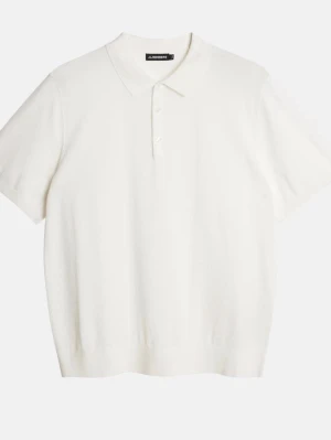 Vit J.lindberg polotopp med kort ärm  - Klassisk vit polotopp med korta ärmar och krage. Toppen har knappar framtill och är tillverkad i ett mjukt material som ger en clean och stilren look. Perfekt att matcha med jeans eller kjol för en enkel men snygg outfit.