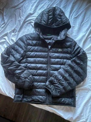 Black Lacoste Puffer Jacket - • Black Lacoste Puffer Jacket In Very Good Condition, No Signs Of Wear, Bought For 260€. Size Is M/L But Fits More Like M.