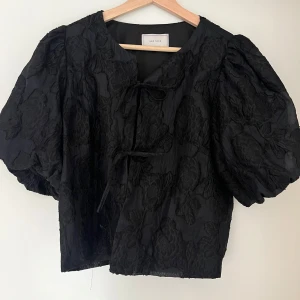 Svart blus från Neo Noir - Supersnygg svart blus från Neo Noir med stora puffärmar i storlek 38 🩷