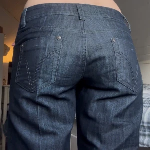 Mörkblå jeans Show Time - Mörkblå jeans från Show Time med bootcut passform och låg midja. Jeansen är i ett mjukt icke stretchigt denimtyg som sitter skönt och ger en snygg siluett. Dem är även uppsprättade och fast tydda längt ner för dem va för korta för mig, men de repar sig inte eftersom jag sydde, be gärna om bild🙌 Säljer dem för dem är för tighta i midjan för mig💔står M men skulle säga att de är mer som en S
