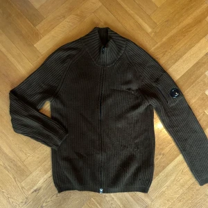 Stickad ZIP från C.P Company - Mörkbrun/Grön Stickad Zip Tröja  C.P Company   Storlek XL passar L-XL  Se Bilder för Flaws👕