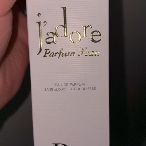 J'adore Parfum d'eau från Dior - Säljer en lyxig J'adore Parfum d'eau från Dior. Flaskan är vit med eleganta gulddetaljer och en rund, genomskinlig kork. Parfymen är alkohol-fri och kommer i en stilren vit förpackning 30 ml använd endast 2 gånger 