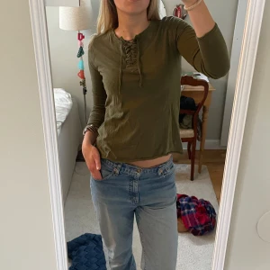  långärmad tröja med snörning - Säljer en khaki långärmad tröja med snygg snörningsdetalj vid halsen.